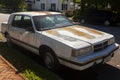 a very old and rusty dodge dynasty car