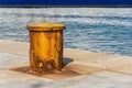 Very old rusty iron bollard on concrete marine dock for boat Royalty Free Stock Photo