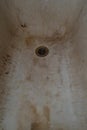 Very old rusty shabby bath close-up. A bath with peeling white enamel old dirty bathtub