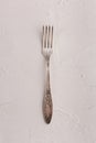 Very old rusty vintage silver fork isolated on a white cement texture background Royalty Free Stock Photo