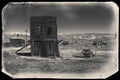 Very old sepia vintage photo with abandoned western building in the middle of a desert Royalty Free Stock Photo