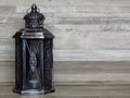 A very old silver lantern. Rustic, retro style. Handicrafts, craftsmanship, light, old house lighting concept.