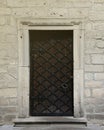 Very old solid door in brick stone wall of castle or fortress of 18th century Royalty Free Stock Photo
