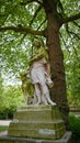A very old statue covered with green moss. Woman with a hunting dog Royalty Free Stock Photo