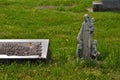 Very old statue and headstone in a cemetery