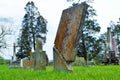 Very old headstone about to fall in a cemetery