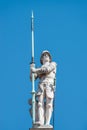 Very old statute heavy armed gatekeeper, medieval warrior with spire in historical downtown of Dresden at blue sky, Germany