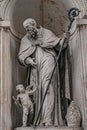 Very old statute of high ranked priest with winged angel in historical downtown of Dresden, Germany