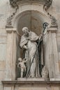 Very old statute of high ranked priest with winged angel in historical downtown of Dresden, Germany