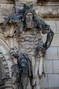 Very old statute of scary gatekeeper, medieval warrior with weapon in historical downtown of Dresden, Germany