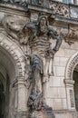 Very old statute of scary gatekeeper, medieval warrior with weapon in historical downtown of Dresden, Germany