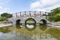 Very old stone bridge over the quiet lake with its reflection in the water Royalty Free Stock Photo