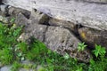 Very old stone cross lying near the foundationat of the wooden church from Poienile Izei, Maramures county. Royalty Free Stock Photo