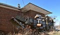 Histori old threshing machine in front of a creamery building