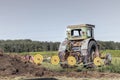 Very old tractor in the field with fertilizer ready to work in agriculture farm Royalty Free Stock Photo