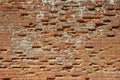 Very old weathered, damaged, badly repaired red brick wall