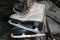 Very Old White and Black Rusty and Dirty Ice Skates Hanging in Warehouse Royalty Free Stock Photo