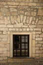 Very old window in brick stone wall of castle or fortress of 18th century. Full frame wall with window Royalty Free Stock Photo