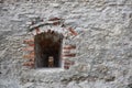 Very old window in brick stone wall of castle or fortress of 18th century. Full frame wall with window Royalty Free Stock Photo