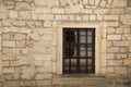 Very old window in brick stone wall of castle or fortress of 18th century. Full frame wall with window Royalty Free Stock Photo