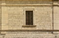 Very old window in brick stone wall of castle or fortress of 18th century. Full frame wall with window Royalty Free Stock Photo