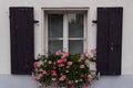 Very old window with wooden shutters and flowers Royalty Free Stock Photo