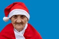 Very old woman 90 years old Mrs Claus with funny expression. Grand-mother or elderly woman with big happy smile wearing Santa Royalty Free Stock Photo