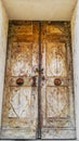 A very old wooden door. Entrance to a three-century old building. Rusty chain and lock Royalty Free Stock Photo