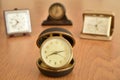 Old small clock on the brown wooden table