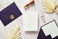 Very peri wedding stationery set. Blank paper wedding invitation card mockup, purple envelopes, rings, dried flowers on marble