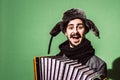 A very positive man with an accordion posing in the studio Royalty Free Stock Photo