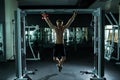 Very power athletic guy , execute exercise tightening on horizontal bar, in sport-hall