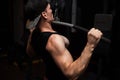 Very powerful athletic guy bodybuilder, exercise for the back and hands. A man in the gym Royalty Free Stock Photo