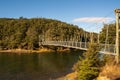 The very remote and isolated South Mavora Lake bridge surrounded by lush thick native forest in rural Southland New Zealand