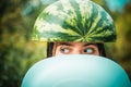 Very ridiculous girl writhes her face holding two halves of watermelon. Crazy people. Sale for entire autumn collection Royalty Free Stock Photo