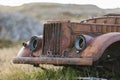 Rusted old car in field in Hawaii Royalty Free Stock Photo