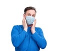 Very scared man in a respiratory mask is afraid of contracting a virus isolated on white background Royalty Free Stock Photo