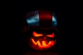 Very scary Halloween pumpkin, with a menacing glance and a grinn