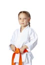 Very serious little girl in a kimono with orange belt
