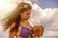 Very sexy woman drinking from a delicious coconut at a Caribbean beach party under a radiant sun, enjoying this party environment Royalty Free Stock Photo