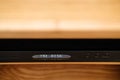 Very shallow focus of a high-end CD player in a wooden cabinet.