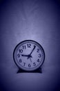 A very simple round black and grey clock against empty background Royalty Free Stock Photo