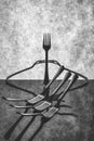 Very simple still life with forks on gray background