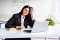 Sleepy and tired business woman on laptop holding a coffee mug in office Royalty Free Stock Photo