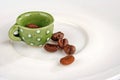 Mini coffee cup with coffee beans-closer