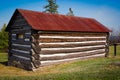 Very Small, Old Log Cabin with Rusted Tin Roof Royalty Free Stock Photo