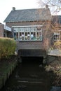 Very small river is running under this old school in village Oud Verlaat
