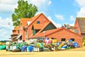 A very small and tiny harbor in Maasholm, Germany, with a huddle of traditional fishing equipement in front of a red house Royalty Free Stock Photo