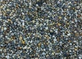 Very small and tiny pebble stone rocks in macro close up in diverse colors garden ground decoration background
