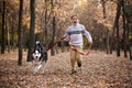 Walking the husky dog in the autumn park Royalty Free Stock Photo